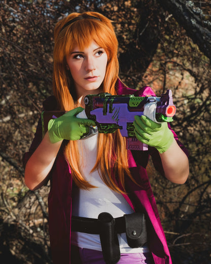 Person with red hair and green gloves holding a colorful toy gun outdoors. Inspired by Daphne from Scooby Doo and the Apocolyptic Comic Book Series.