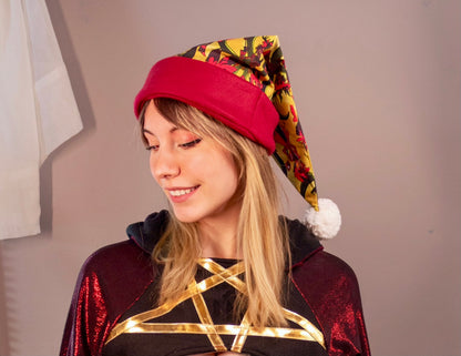 Person wearing a colorful hat and a costume with a star design on a neutral background. Print is of Alastor from Hazbin hotel.