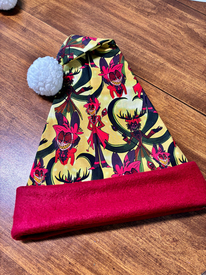 Colorful patterned beanie with a red band on a wooden surface. Print is of Alastor from Hazbin hotel.
