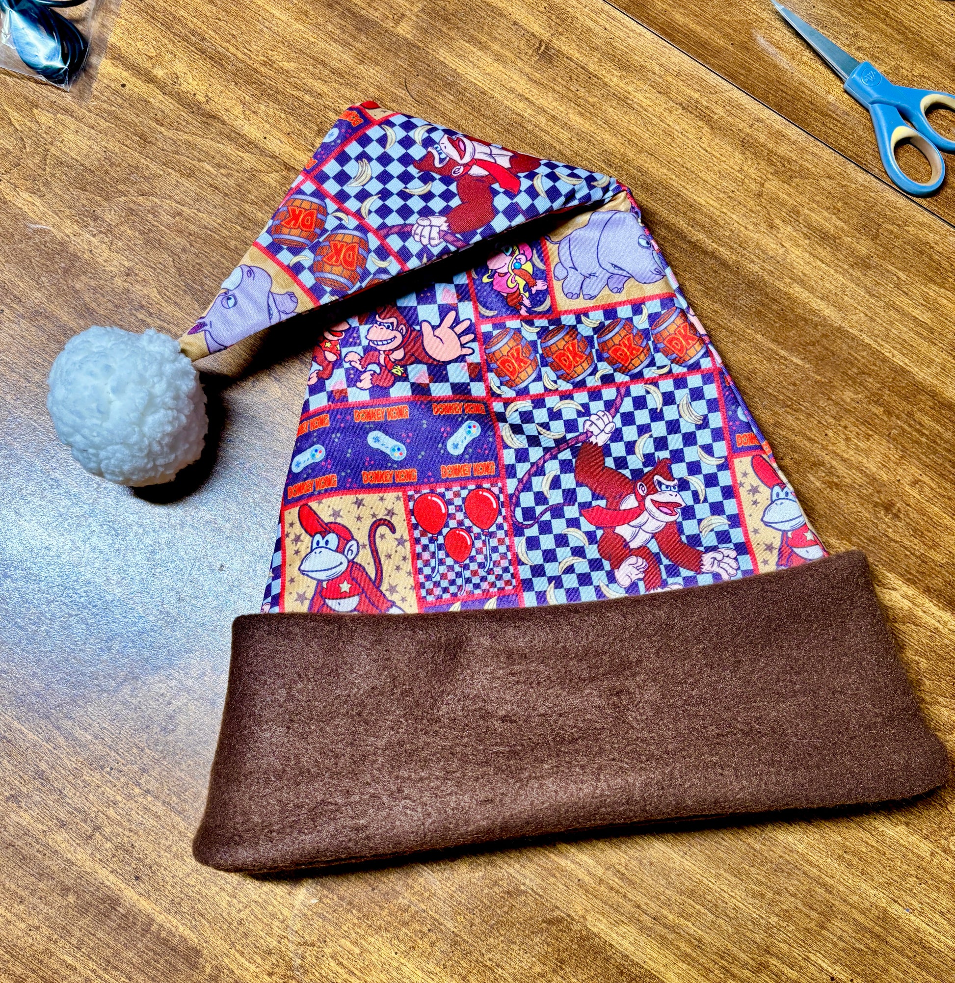 Inspired by Donkey Kong Christmas Sanata laying on a wood table.