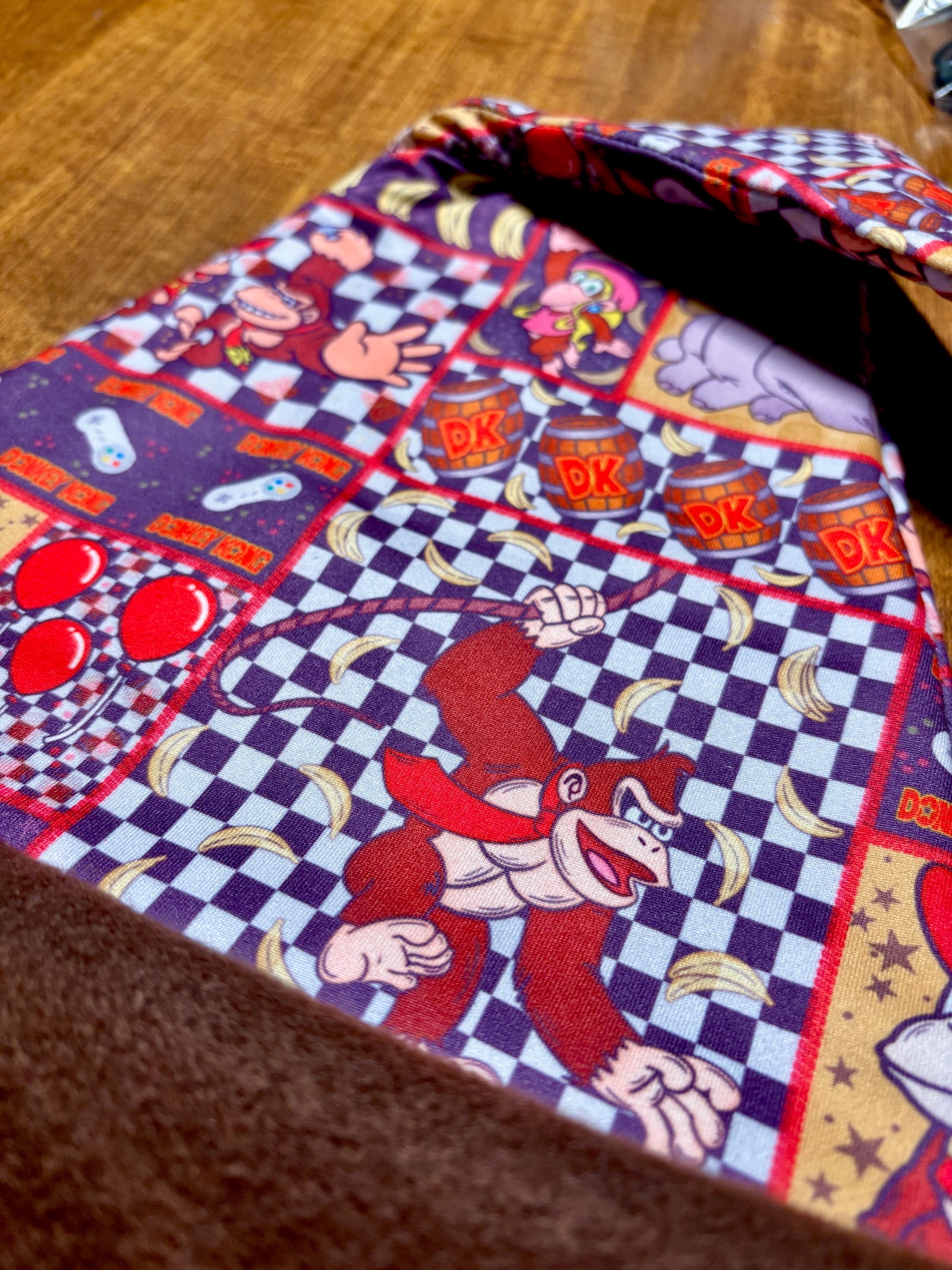 Fabric with cartoon character pattern on a wooden surface. Inspired by Donkey Kong