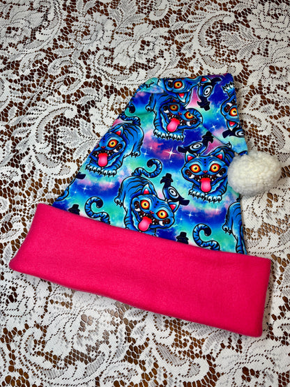 Pink fabric with a blue patterned fabric on top, on a lace background. Pattern is of Deroy Tiger from Kpop Demon Hunters