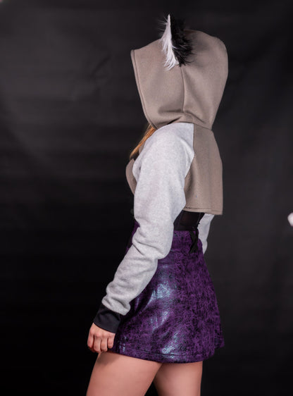 Person wearing a hoodie with wolf ears on a black background. Shrug is inspired by Loona from Helluve Boss. Showing the side veiw and arms
