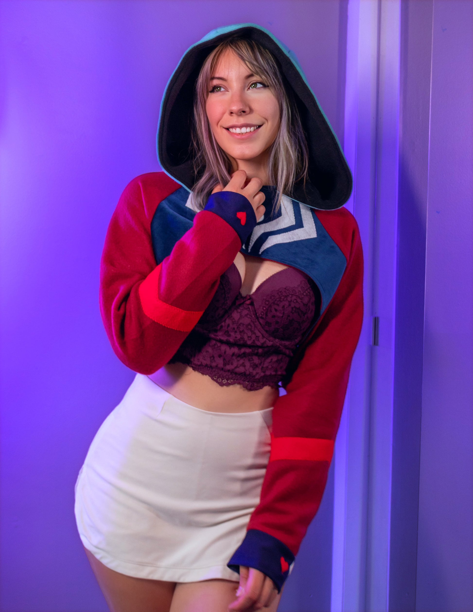 Asmodeus Cosplay cropped hoodie shrug inspired by Helluva Boss shown on a model with a purple background and matching outfit. 