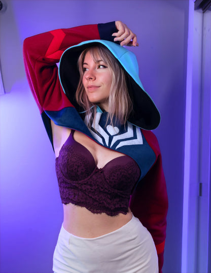 Asmodeus Cosplay cropped hoodie shrug inspired by Helluva Boss shown on a model with a purple background and matching outfit. 