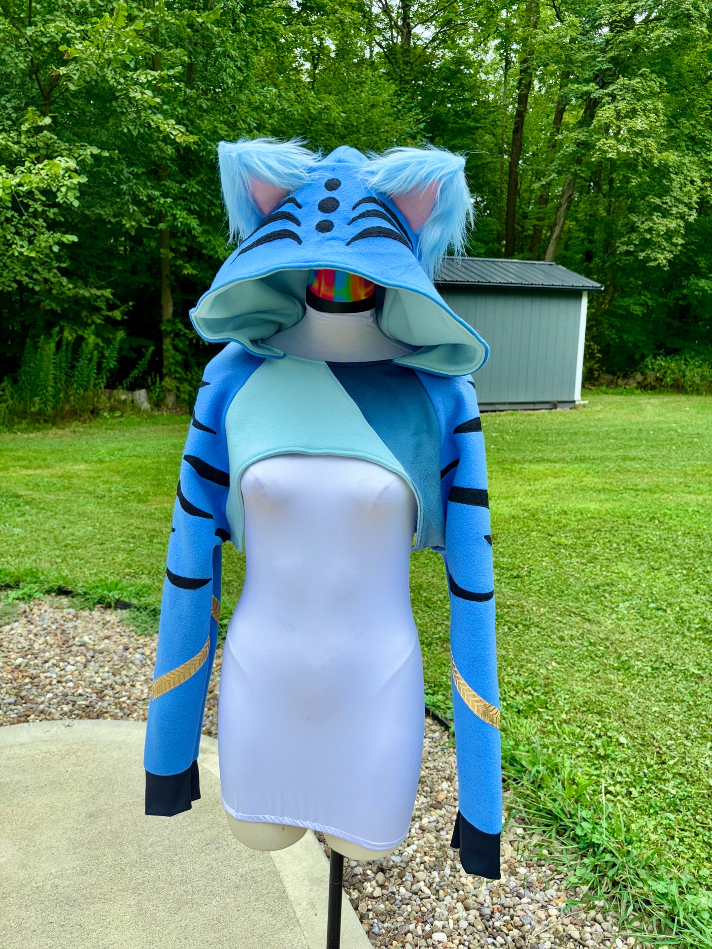  a cosplay shrug inspired by Derpy Tiger from Kpop Demon Hunters. It is different shade of blue with  character designs