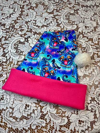 Pink fabric with a blue patterned fabric on top, on a lace background. Pattern is of Deroy Tiger from Kpop Demon Hunters