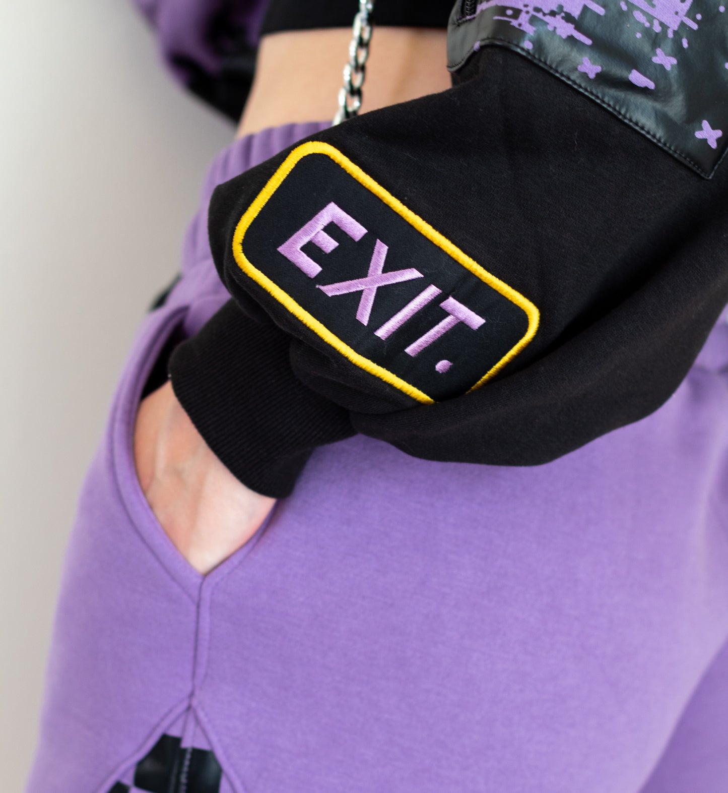 Black waist bag with 'EXIT' text worn by a person in purple pants.  Inspired by Jax from The Amazing Digital Circus TADC