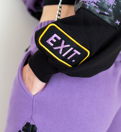 Black waist bag with 'EXIT' text worn by a person in purple pants.  Inspired by Jax from The Amazing Digital Circus TADC