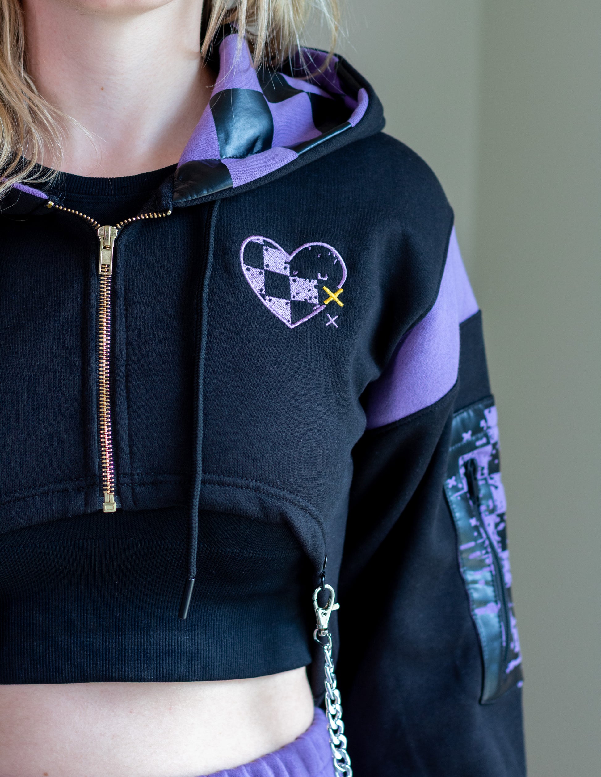 Black and purple hoodie with a heart design on a neutral background.  Inspired by Jax from The Amazing Digital Circus TADC