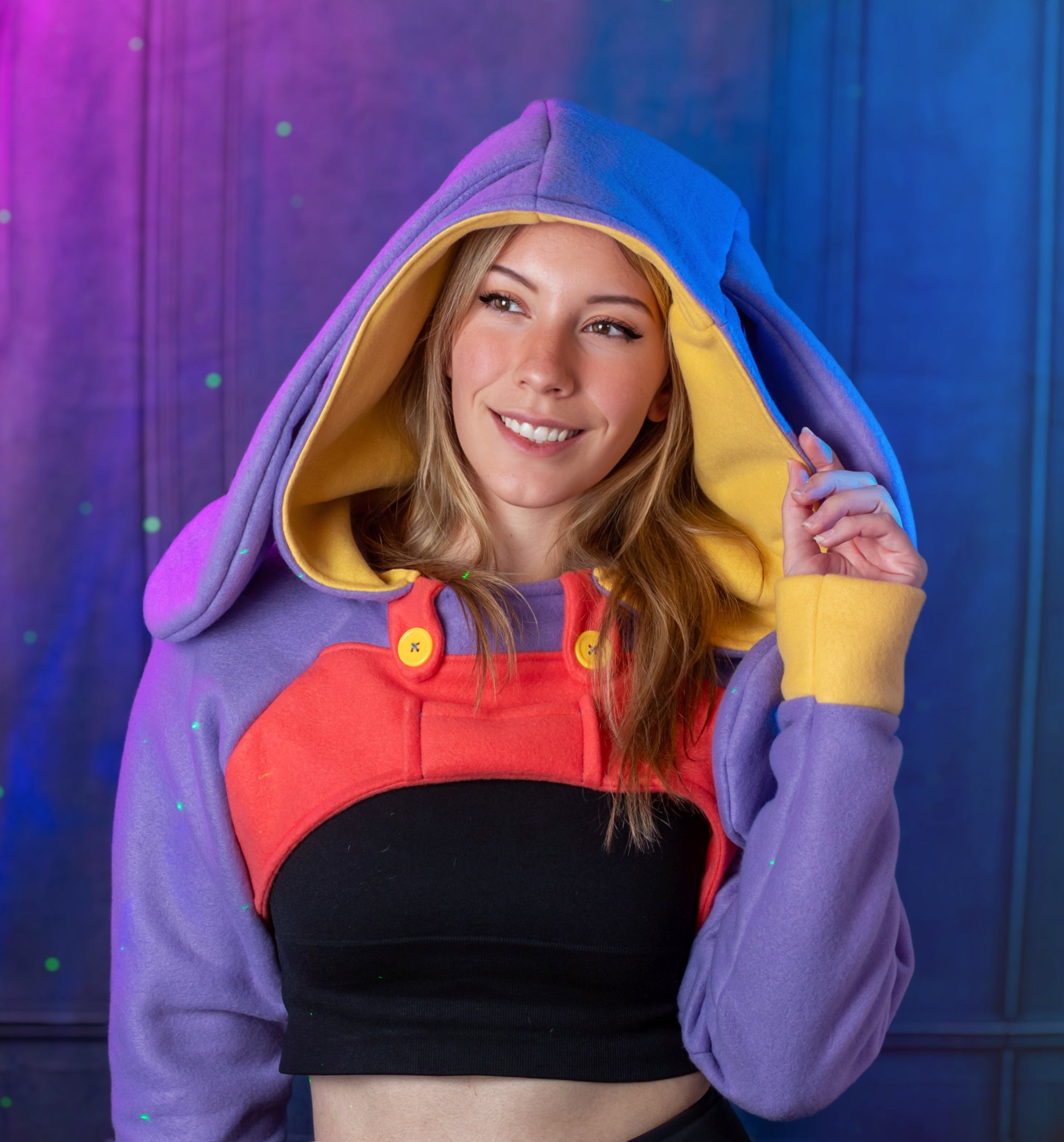 Person wearing a colorful hoodie with a red and black design underneath against a blue and purple gradient. Inspired by Jax from the Amazing digital circus.