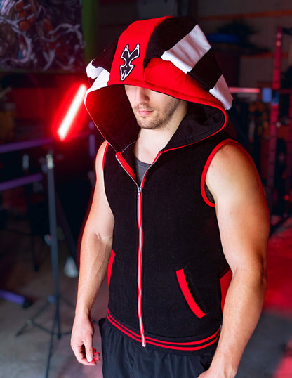 Person wearing a black, red, and white hoodie with a logo on a blurred background. Blitz cosplay inspired by Helluva Boss. sleevelss hoodie