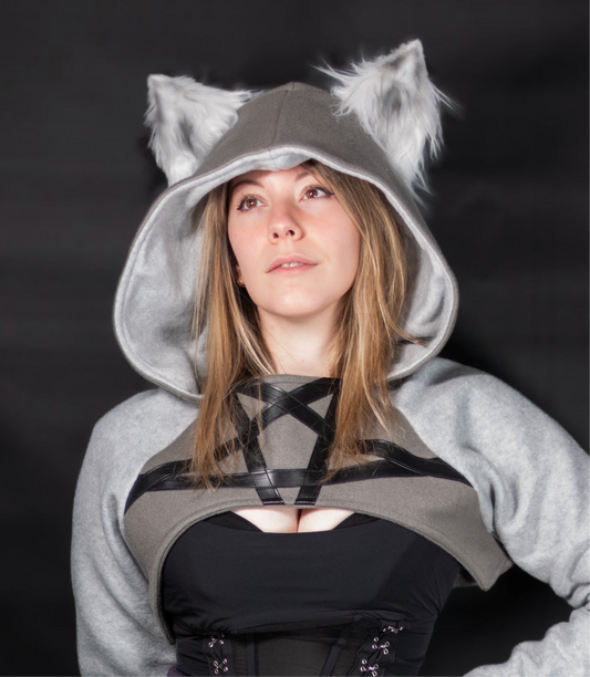 Person wearing a gray hoodie with wolf ears against a black background. Inspired by Loona from Helluva Boss