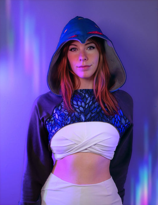 Person wearing a Stolas outfit with a hood and white top against a purple background. Inspired by Stolas from Helluva boss. 