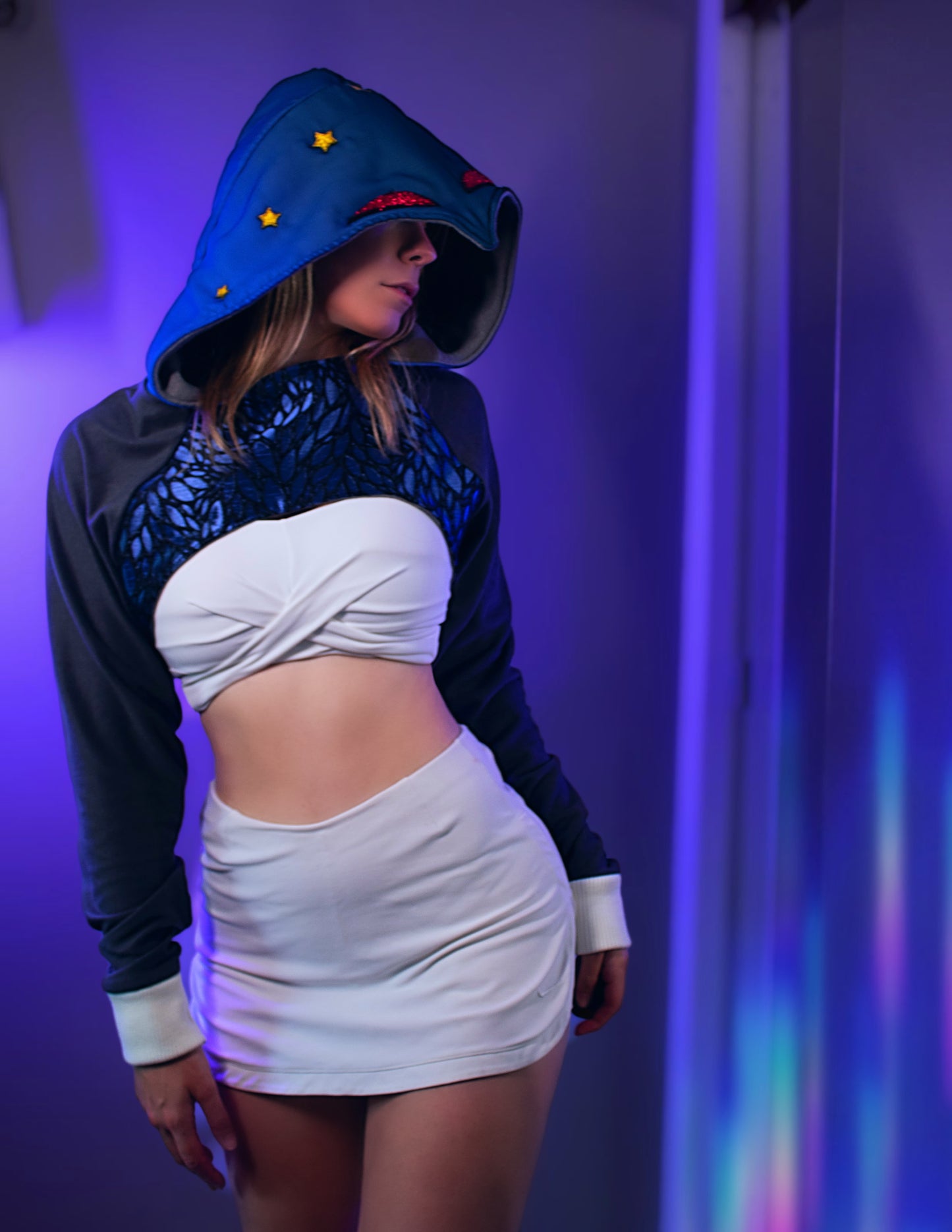 Person wearing a Stolas outfit with a hood and white top against a purple background. Inspired by Stolas from Helluva boss. 